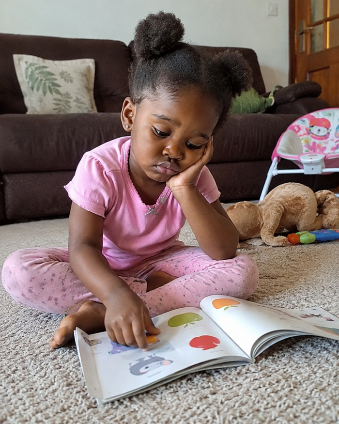 Child bored and struggling with plain alphabet book